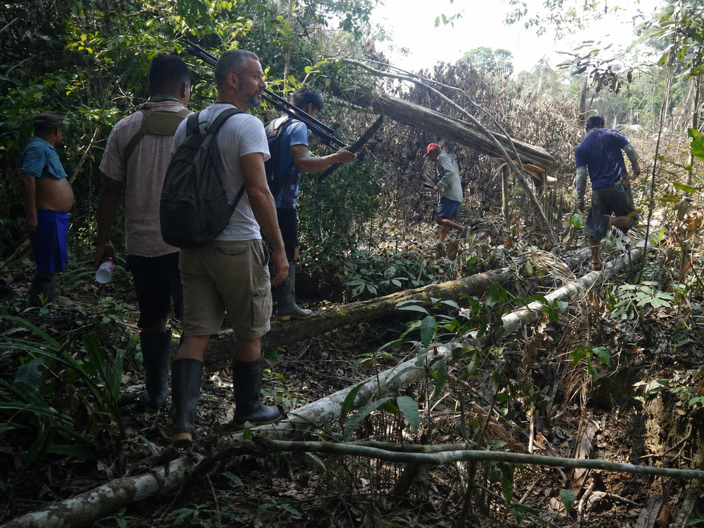 Ameyalli and companions walking through dense Amazon jungle